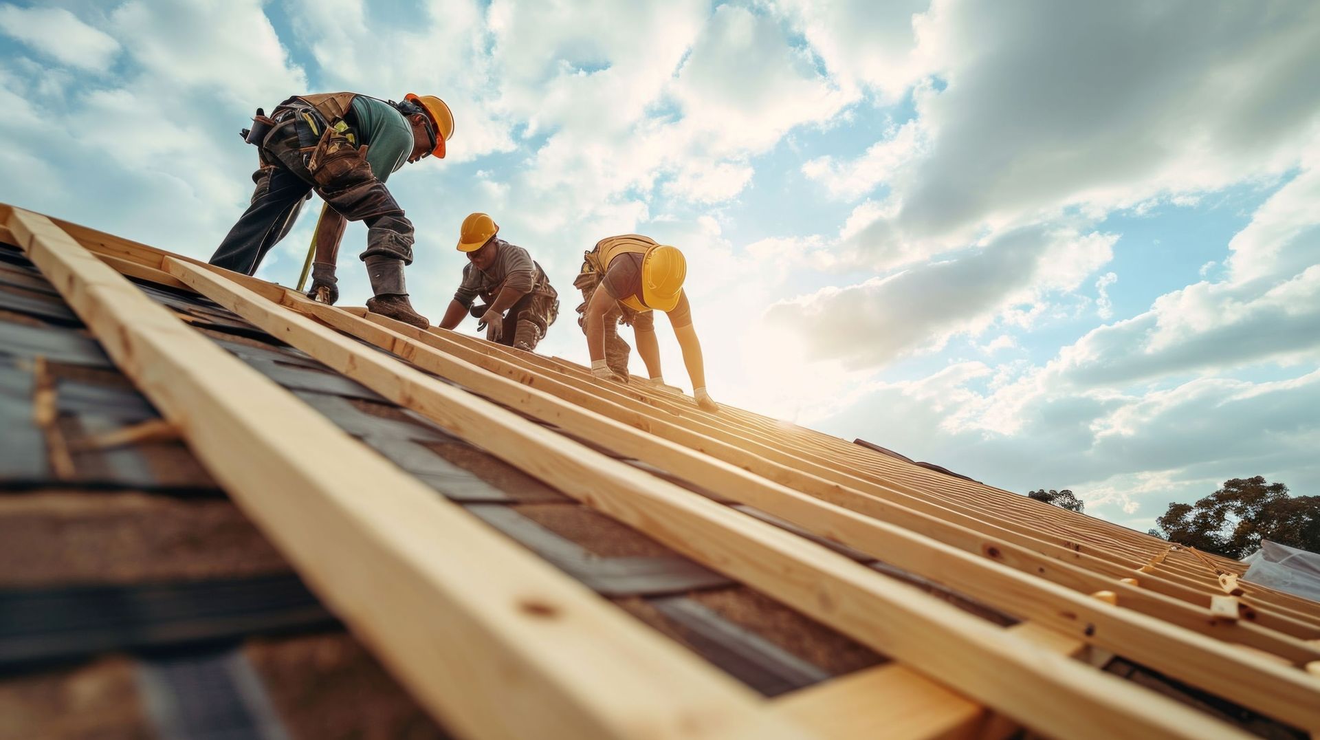 Construction workers install new roofs, roofing tools and fall protection devices