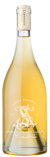 A bottle of light yellow wine with an ornate white logo featuring the letters 