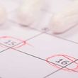 Close-up of a calendar page with dates 15 and 16 circled in red.