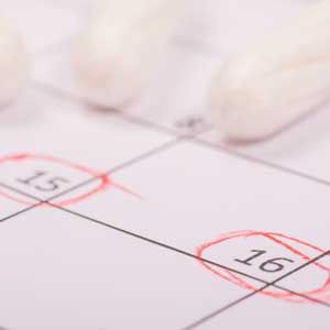 Close-up of a calendar page with dates 15 and 16 circled in red.