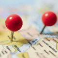 Two red pushpins marking locations on a map, one near Saudi Arabia.
