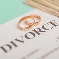Two gold wedding rings on a divorce document