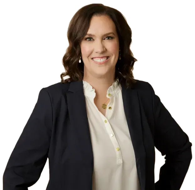 Smiling professional woman in a navy blazer and white blouse against a white background