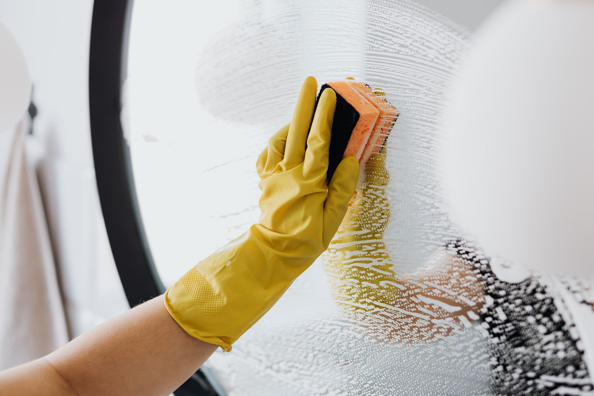 Person with yellow gloves wiping mirror down- Thorough Cleaner in Toowoomba, QLD