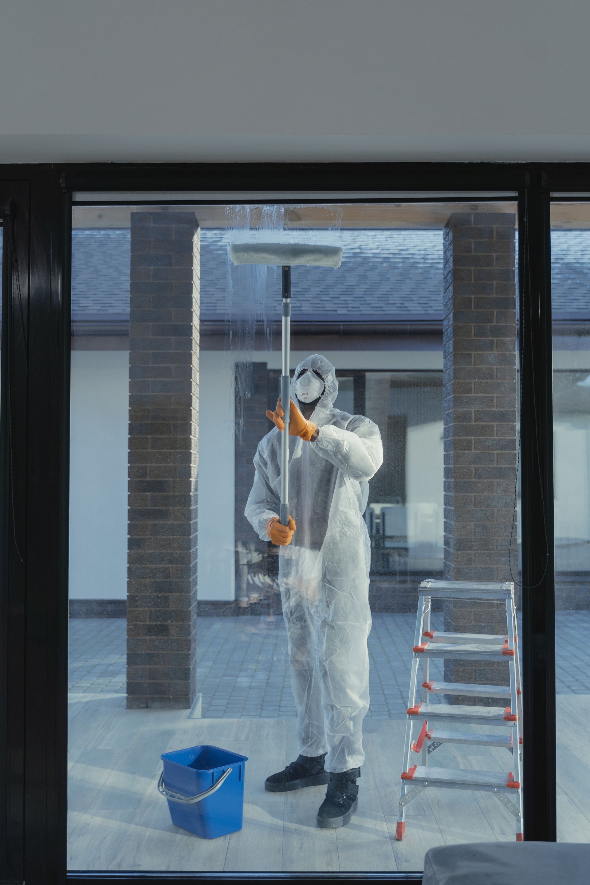 Man cleaning outside office windows - Cleaning Services in Darling Downs, QLD