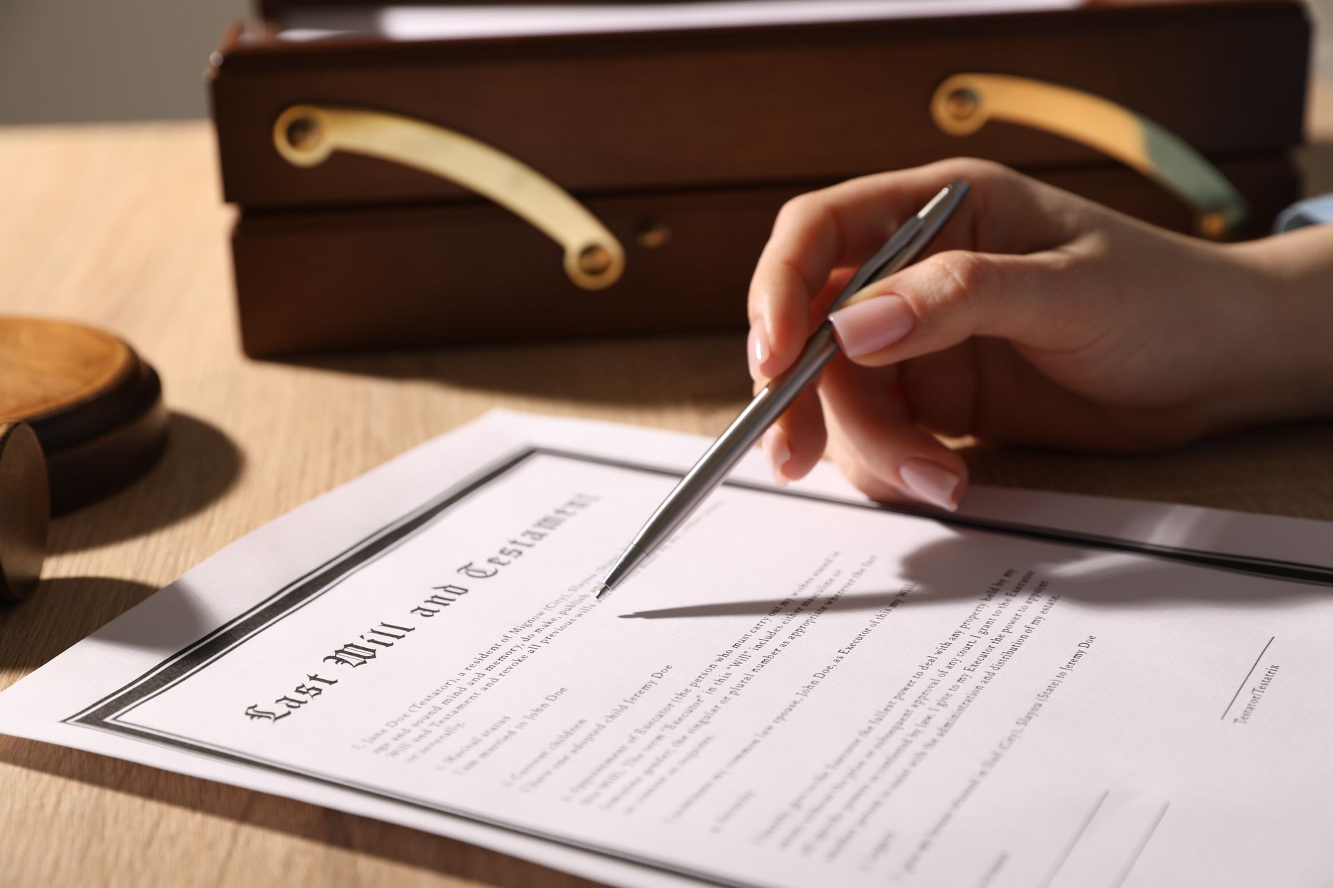 A woman is signing a last will.