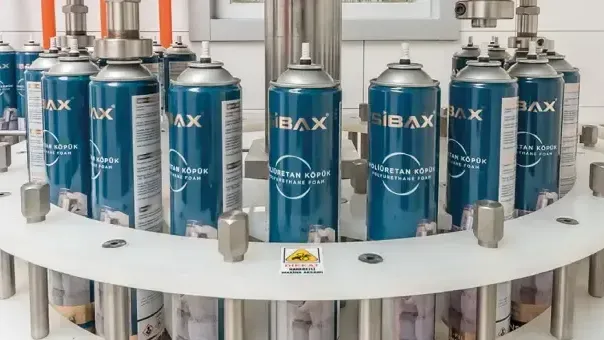 A bunch of spray cans are sitting on top of a table.