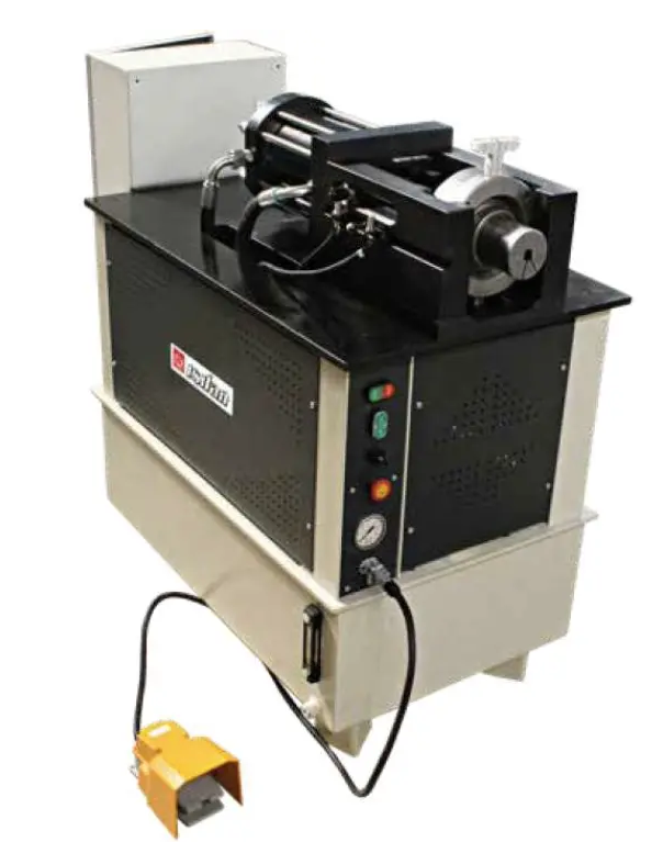 A machine with a yellow foot pedal is sitting on a table.