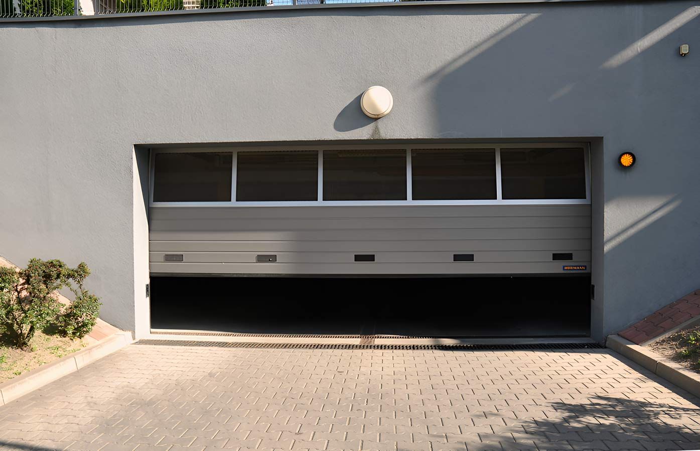 A Garage Door With a Light on Top of It — Mackay Garage Doors in Andergrove, QLD