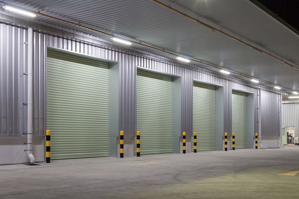 A Row of Garage Doors in a Warehouse at Night — Mackay Garage Doors in Andergrove, QLD