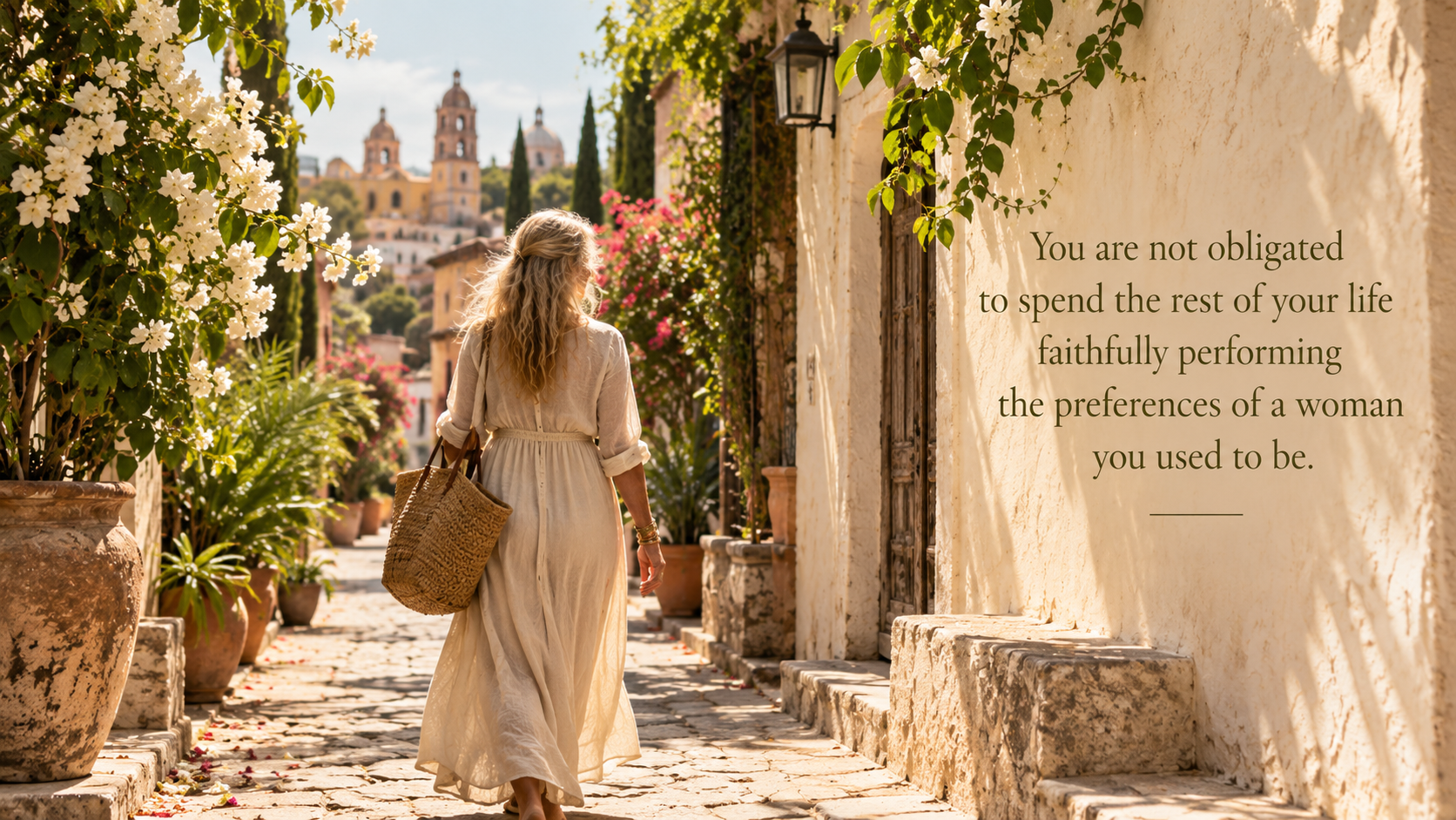 Blonde woman walking away along a sunlit Mexican cobblestone street lined with lush greenery and cre