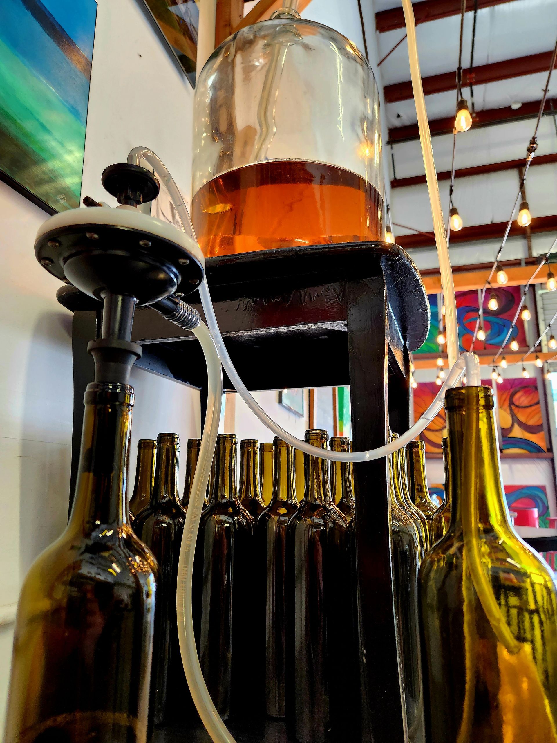 A Row Of Wine Bottles With A Hose Attached To Them | Kailua, HI | Oeno Winemaking