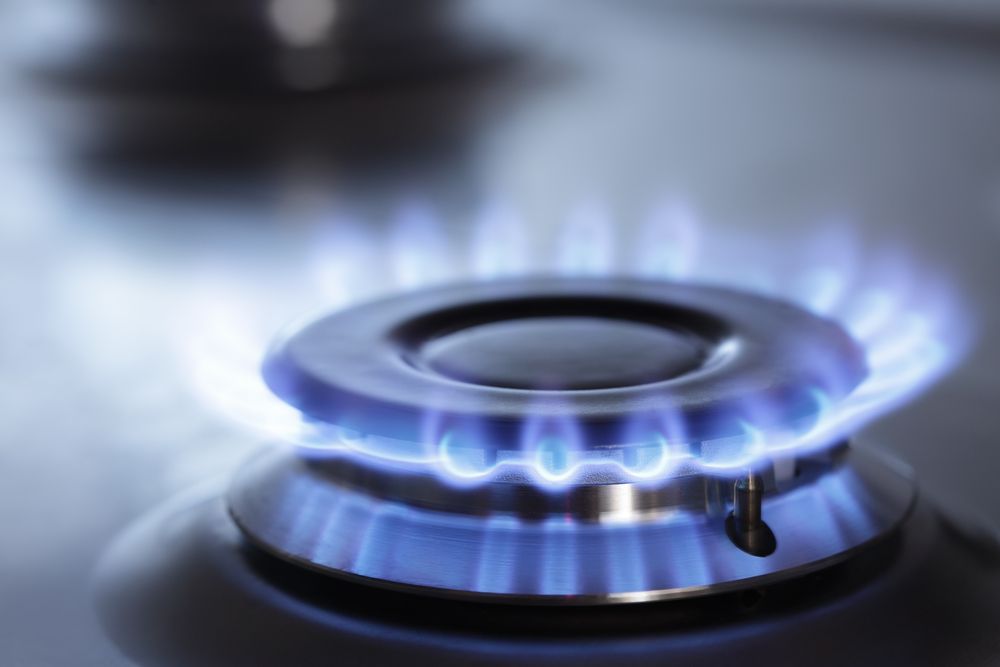 Blue Flame Burning on a Gas Stove Burner — Holders Electrical In Tenterfield, NSW