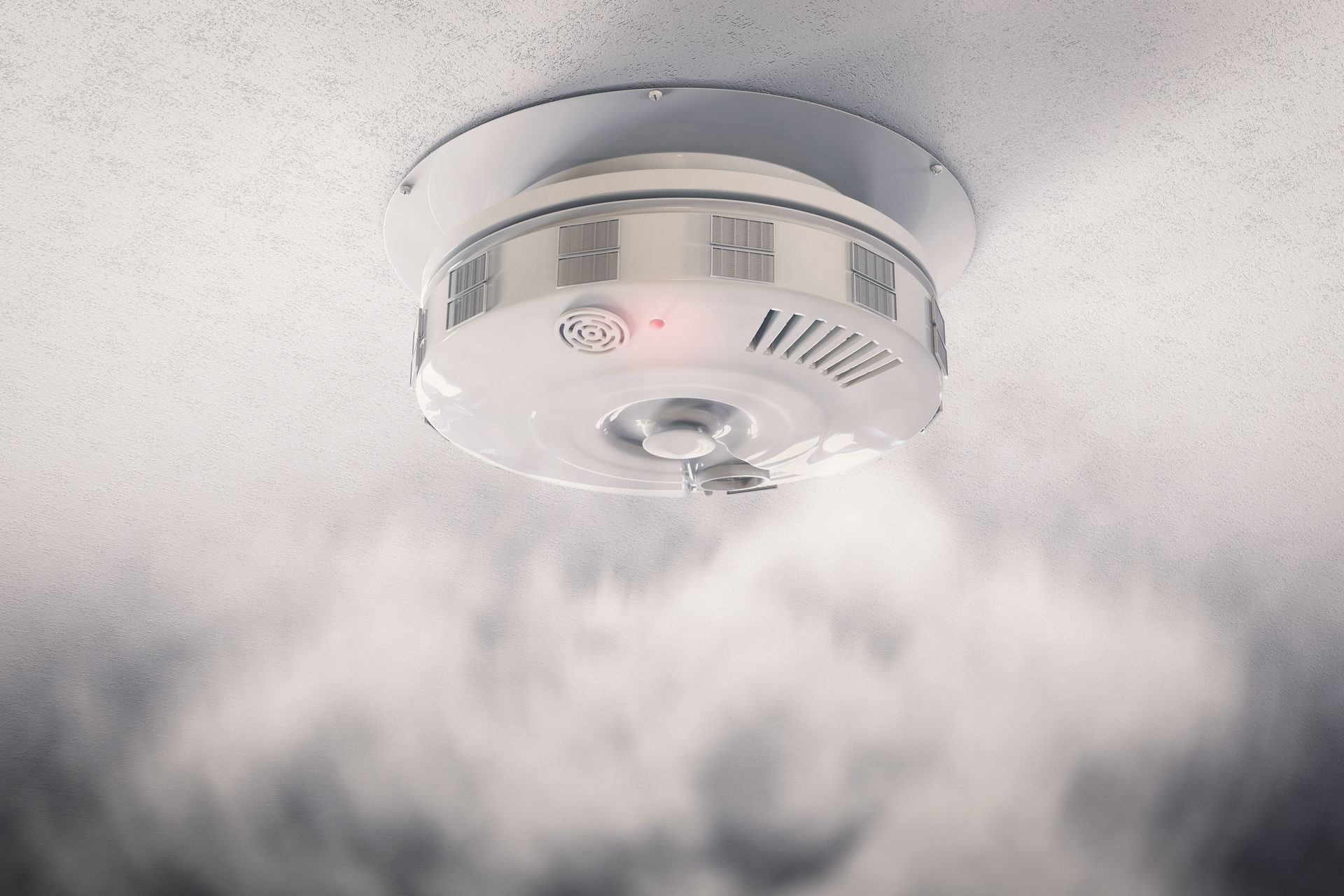 Smoke Detector on Ceiling, Smoke Billowing Below. Red Light Illuminated — Holders Electrical In Stanthorpe, QLD