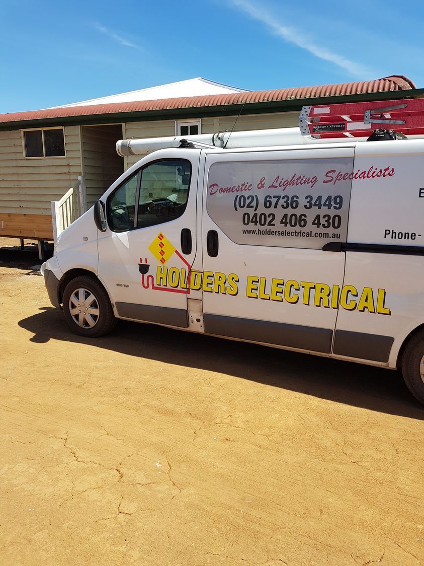 White Van With Hunter's Electrical Logo Parked in Front of a House, Under a Blue Sky  — Holders Electrical In Tenterfield, NSW 