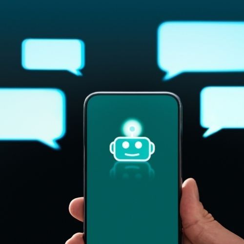 Hand holding phone with chatbot icon, speech bubbles in background.