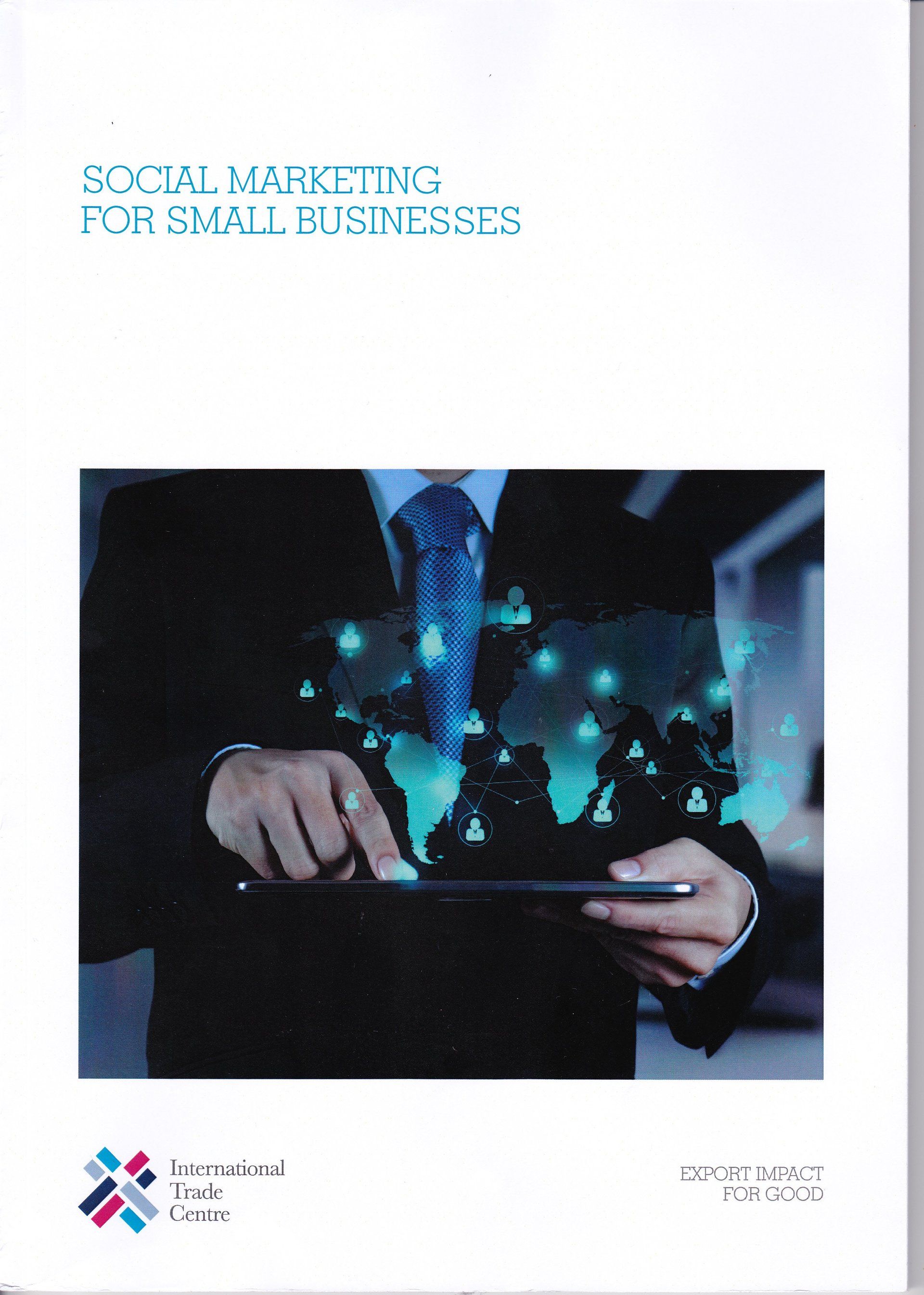 A man in a suit and tie is holding a tablet in his hands.