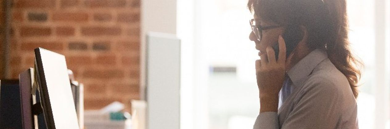 Marketer on phone with ideal clients - Evaluate your online presence blog by Mawazo Marketing