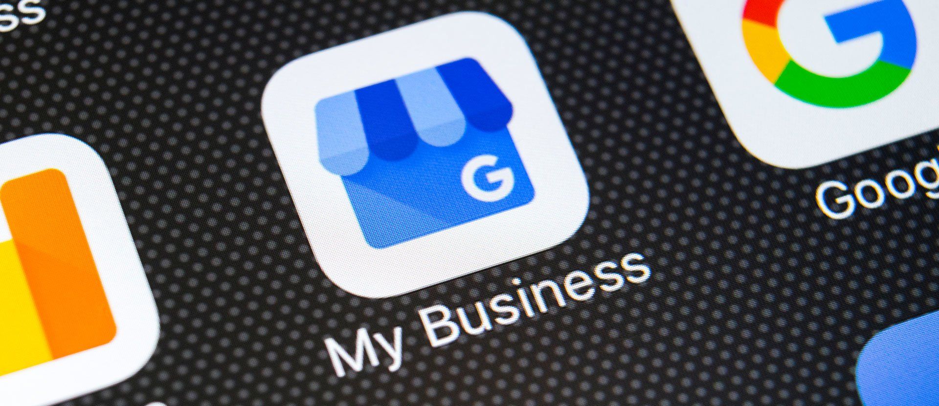 Close-up of the My Business app icon on a smartphone home screen, blue storefront with a white “G”
