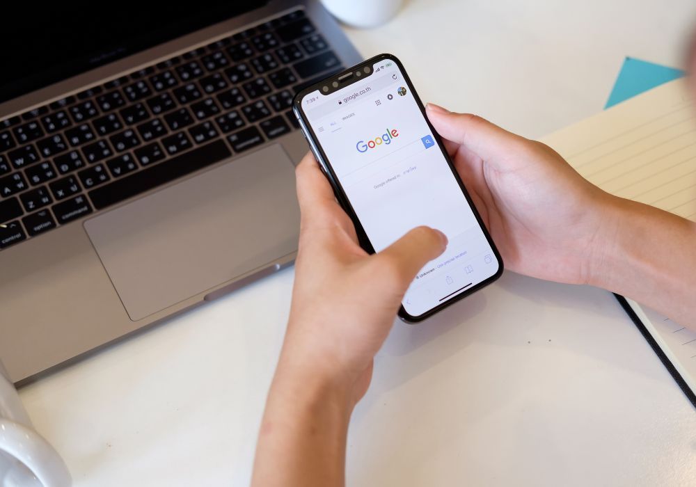 a person is searching google on their phone