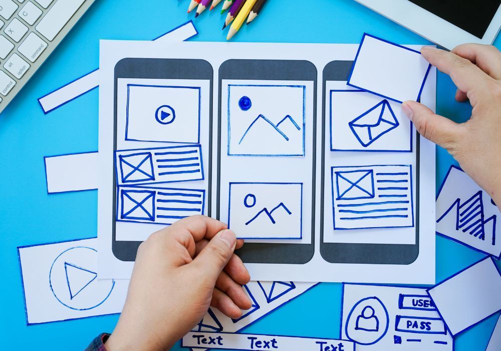 a person is holding a piece of paper showing mobile responsiveness