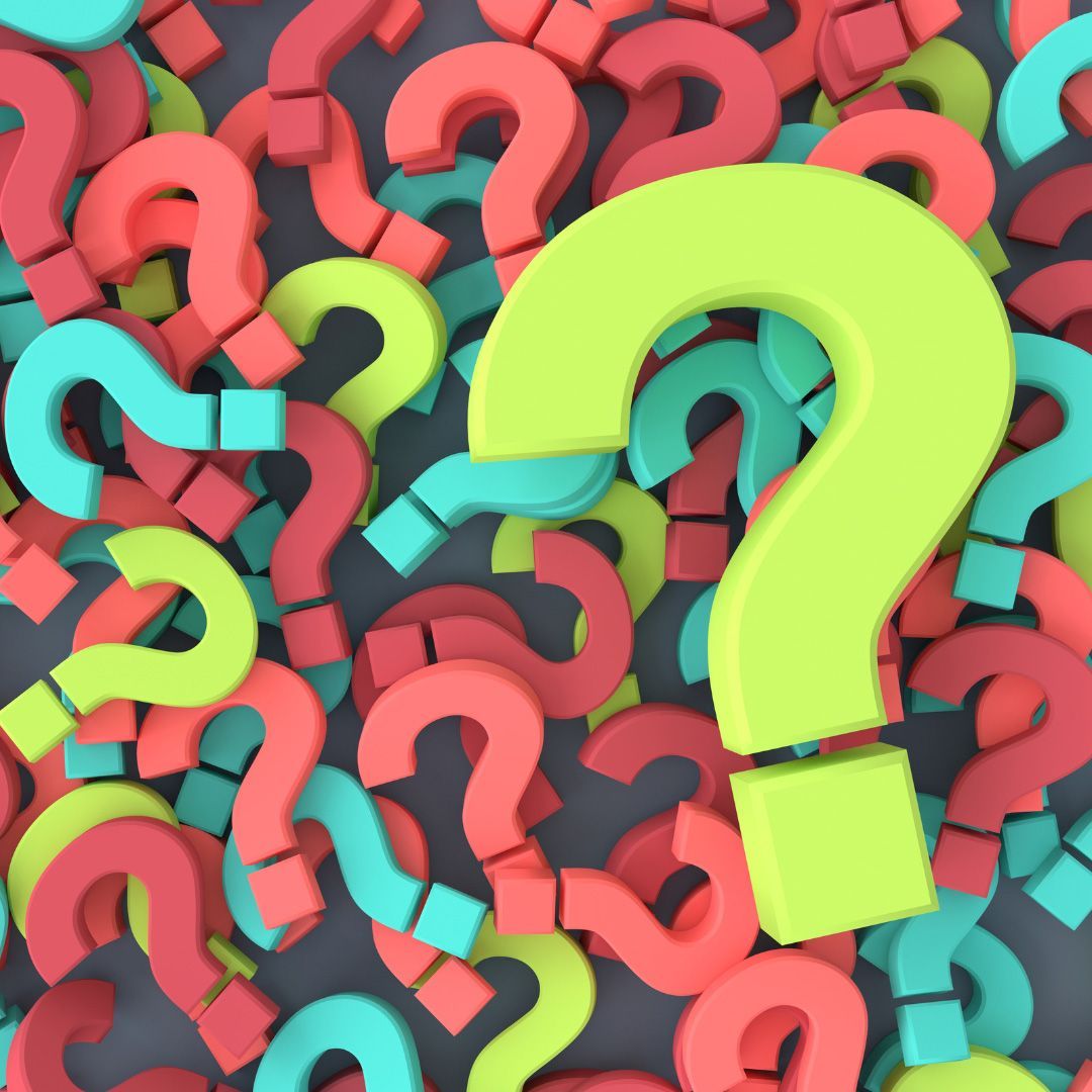 A pile of colorful question marks with a yellow one in the middle