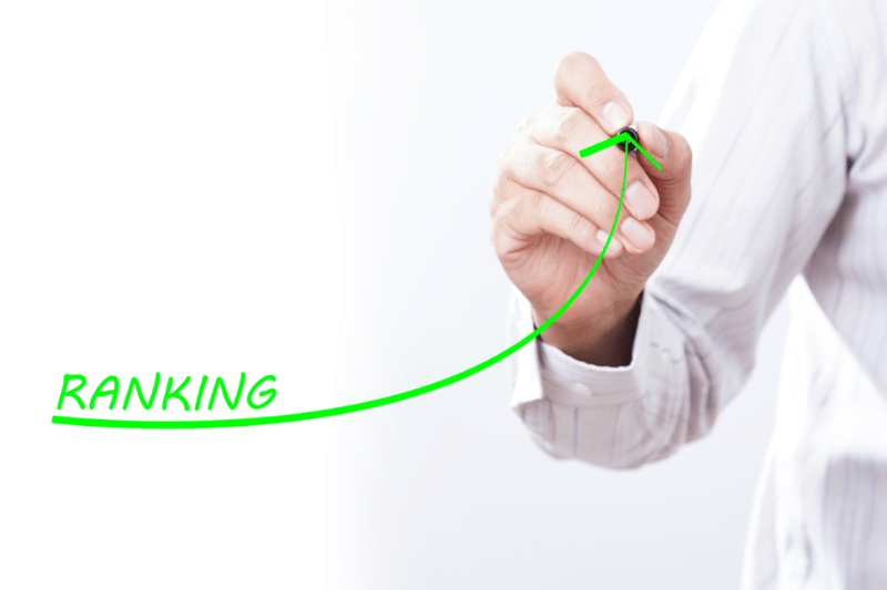 A person is writing the word ranking on a green line.