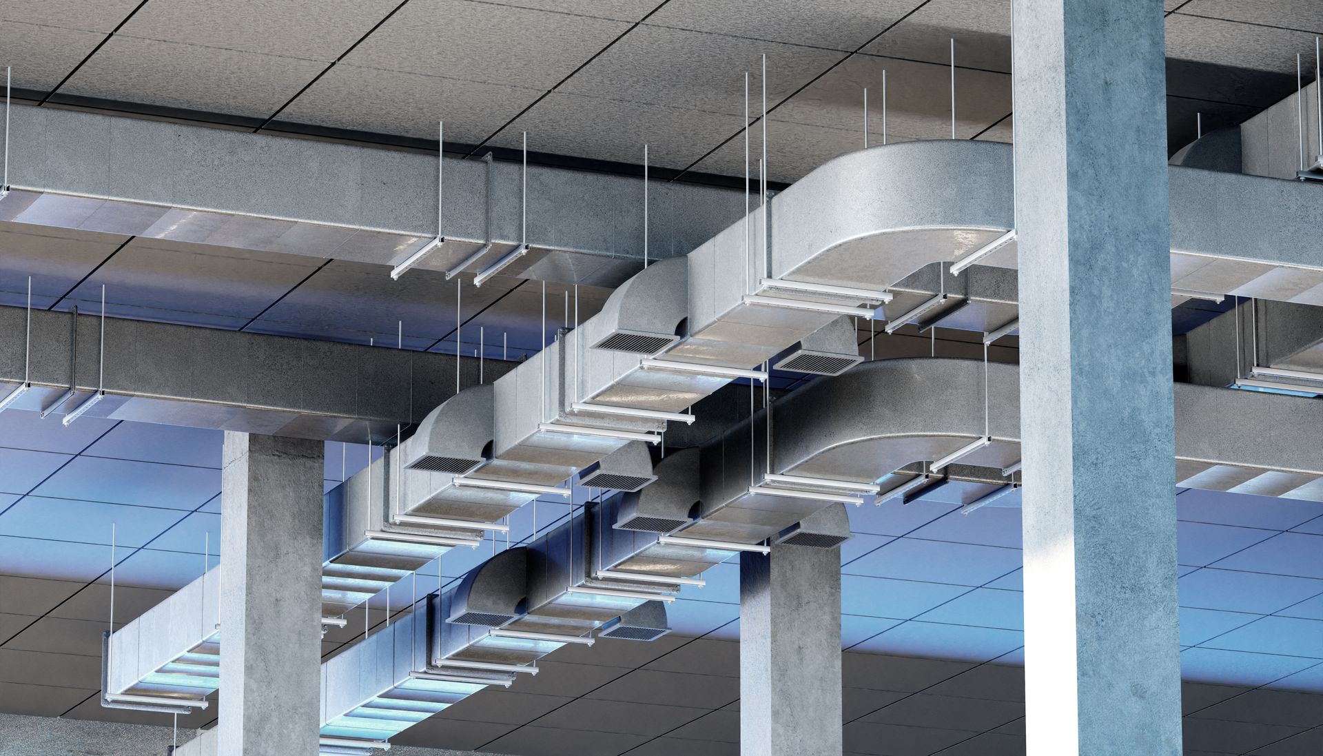 Ceiling ductwork and support columns inside a modern industrial building.