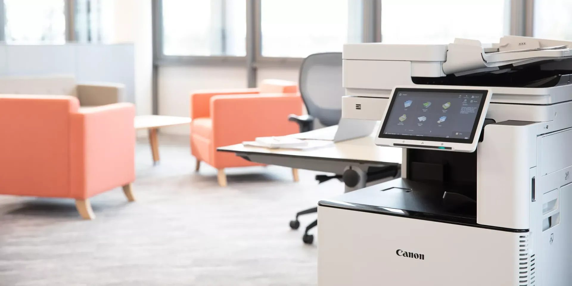 A printer is sitting on top of a desk in an office.