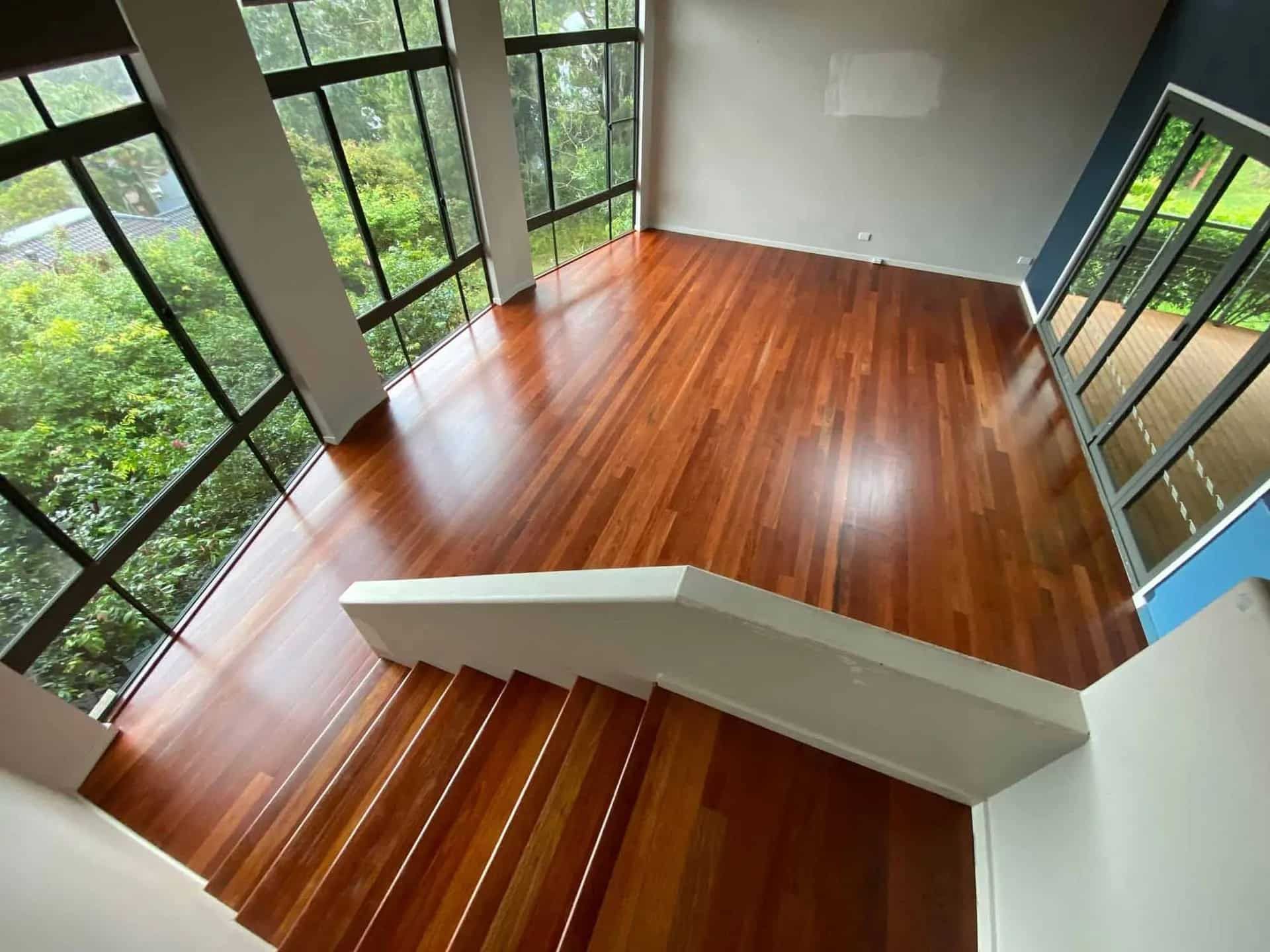 A Room With A Polished Wooden Floor And Stairs And A Lot Of Windows — Brett Hall Floorsanding in Laurieton, NSW