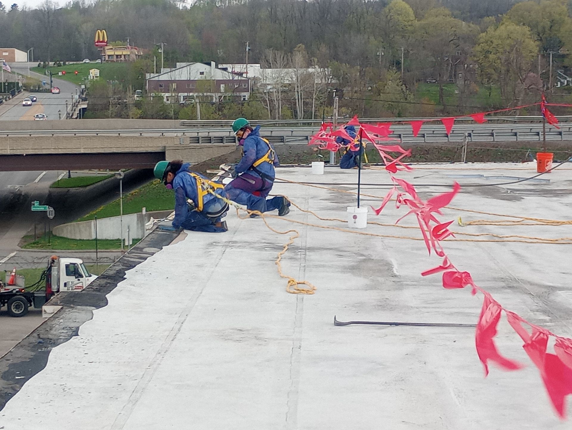 Two MP Environmental Services workers on the roof of the Beechnut Facility in New York