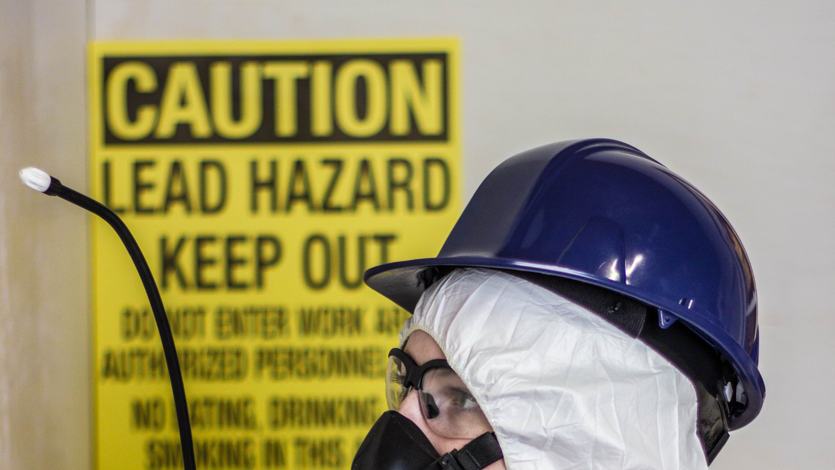 Lead abatement specialist performing lead removal on a building.
