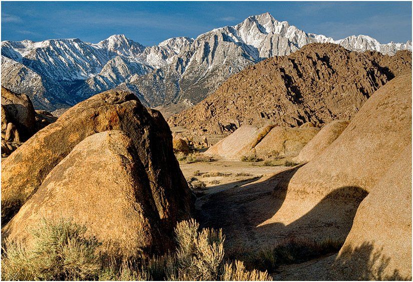 A desert landscape with mountains in the background