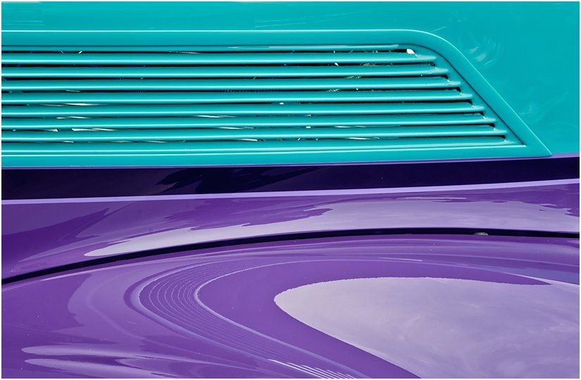 A close up of a blue and purple car hood