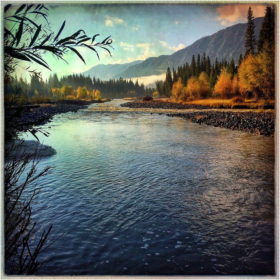 A picture of a river with mountains in the background