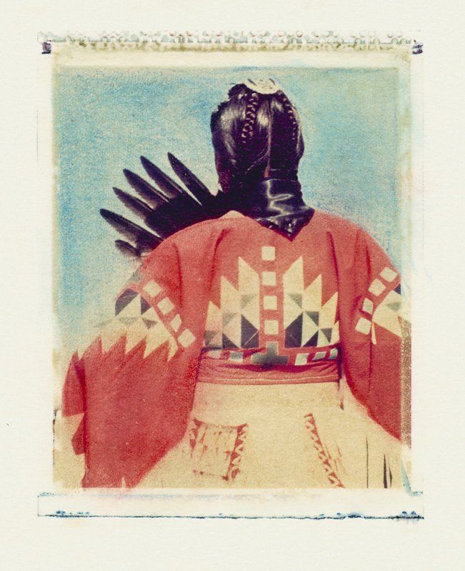 A picture of a native american with a helmet on his head