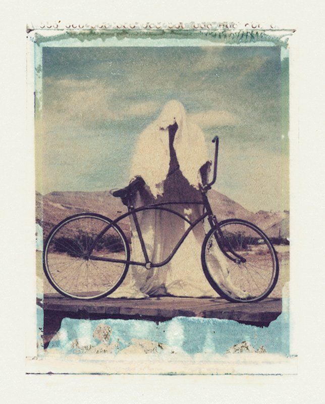 A ghost is riding a bike on a bridge