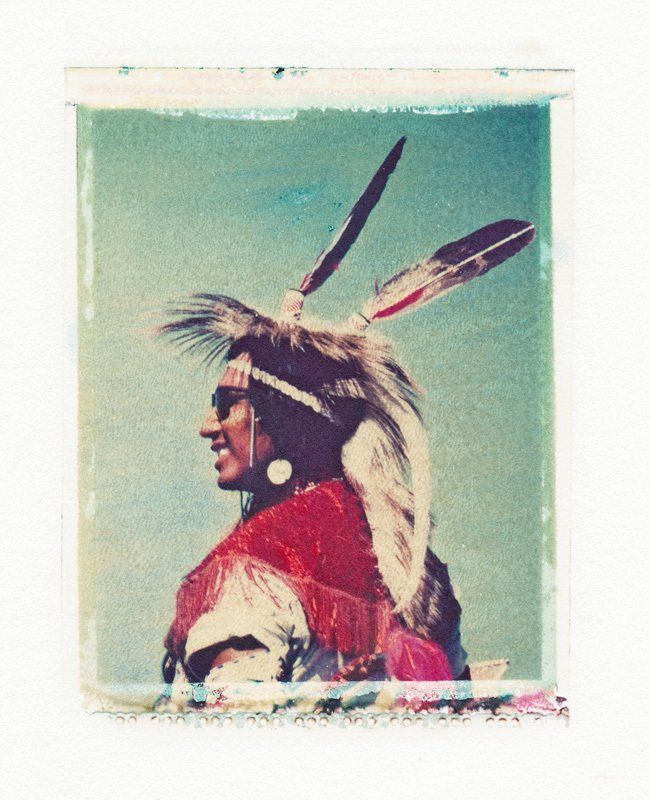 A picture of a native american with feathers on his head