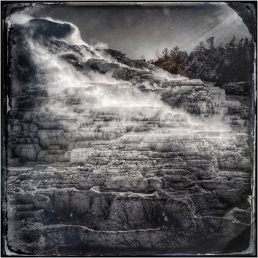 A black and white photo of a waterfall