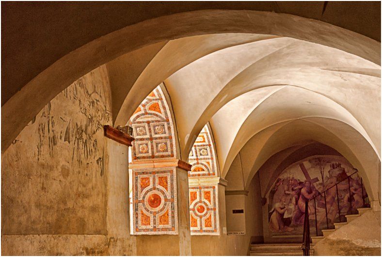 A very old building with arches and stained glass windows