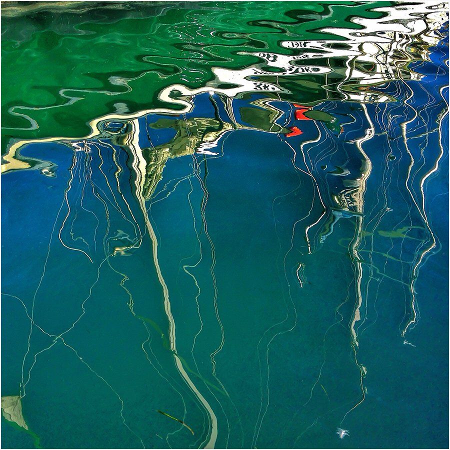 A painting of a body of water with a red letter k in the middle