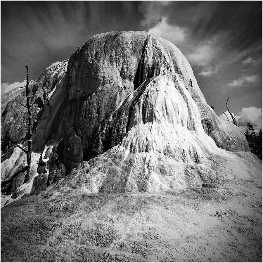 A black and white photo of a large rock formation