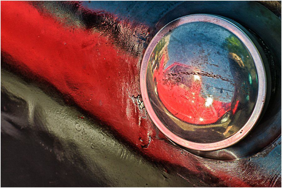 A close up of a red eye with a magnifying glass