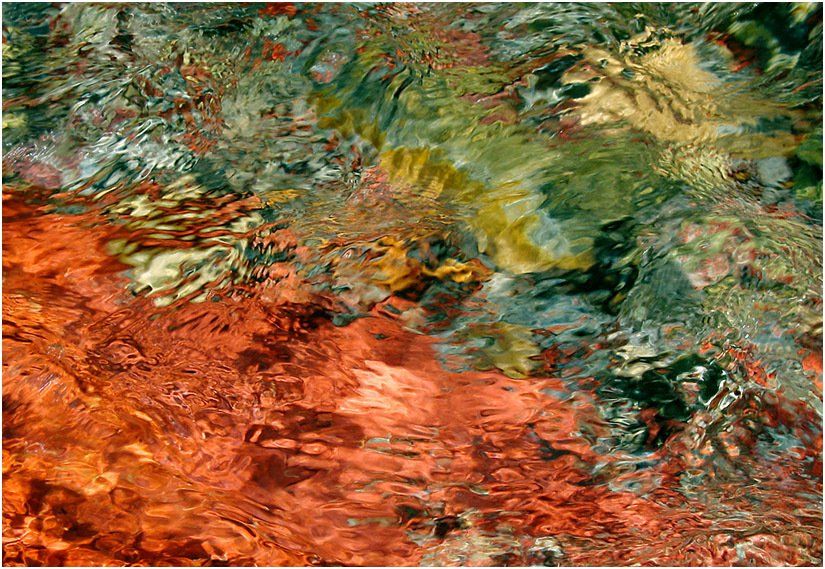 It looks like a painting of a river with a lot of colors.