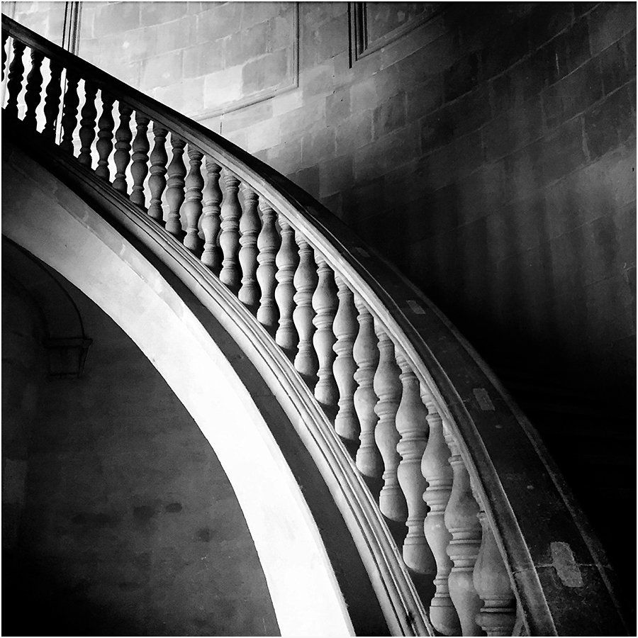 A black and white photo of a curved staircase