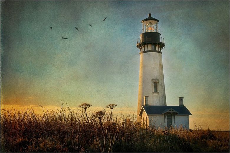 A lighthouse in a field with birds flying in the background