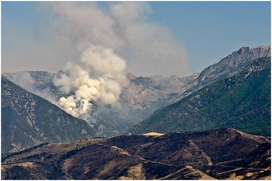 Smoke from forest fire on mountain range.