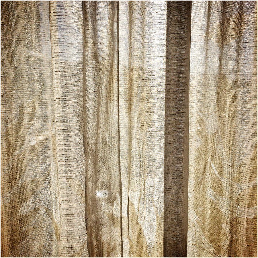 A close up of a curtain with a striped pattern