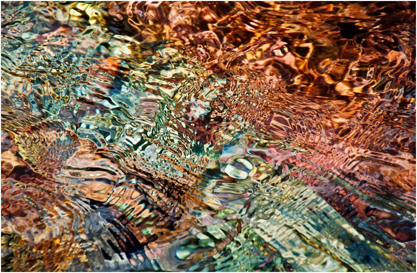 A close up of a painting of a river with a lot of rocks in it.