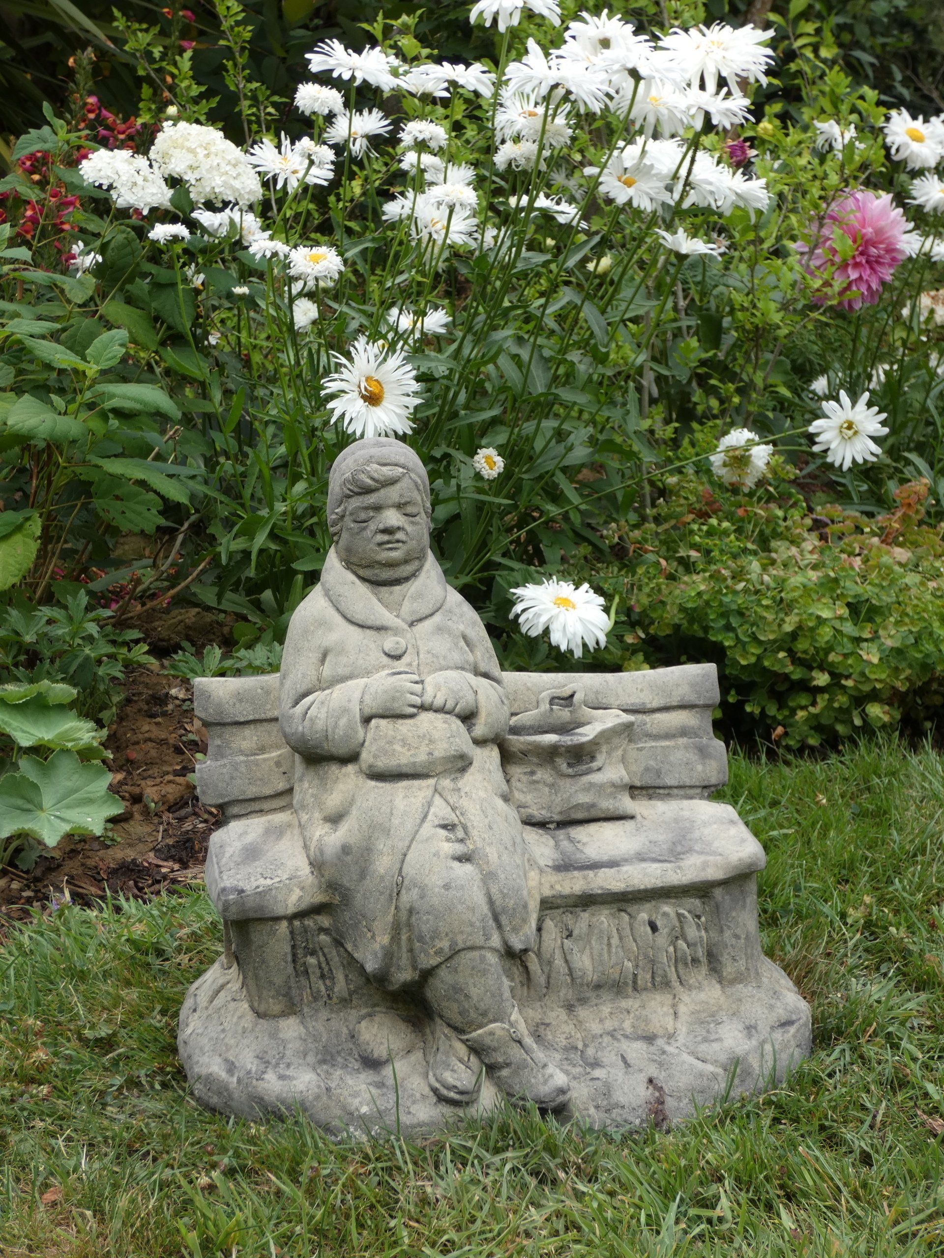 old lady on bench stone garden statue